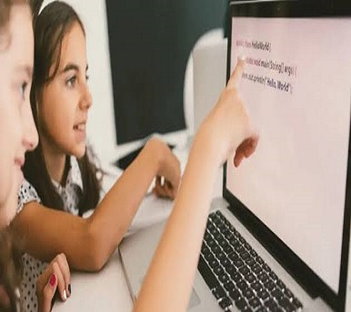 Child in our academy reading from laptop